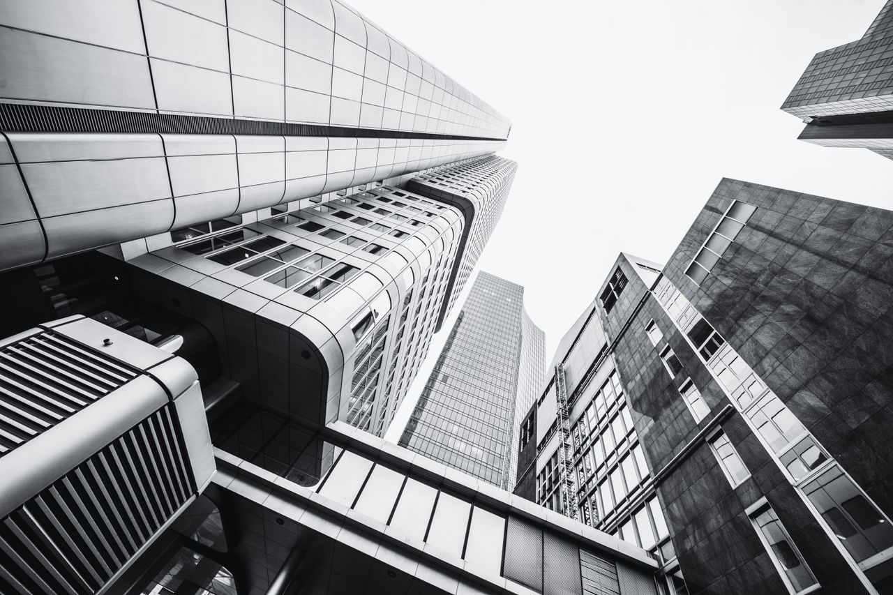 Dramatic low angle shot of modern skyscrapers in monochrome.